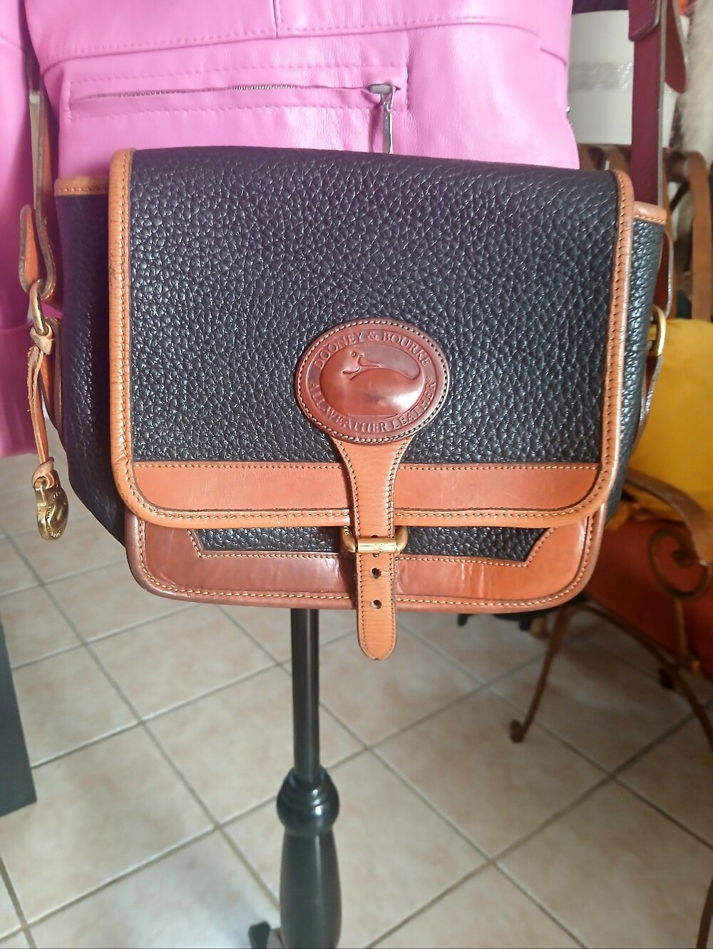 Vintage Dooney & Bourke Black with Brown Trim Pebbled Leather Messenger Bag.